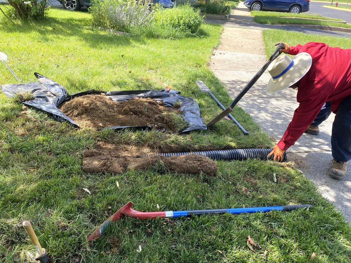 Green Leaves crew installing drainage solution in yard